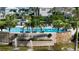 Community pool area features lush landscaping, fountains, and lounge chairs for relaxation at 3540 Mistletoe Ln, Longboat Key, FL 34228