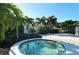 Community hot tub area surrounded by lush landscaping and palm trees at 3540 Mistletoe Ln, Longboat Key, FL 34228