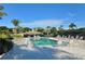 Community pool area with lounge chairs, covered seating, and mature palm trees at 3540 Mistletoe Ln, Longboat Key, FL 34228