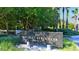 Bay Isles Beach Club private sign with palm trees and tropical foliage at 3540 Mistletoe Ln, Longboat Key, FL 34228