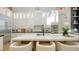 Elegant kitchen with a large island, modern appliances, and stylish pendant lighting at 3540 Mistletoe Ln, Longboat Key, FL 34228