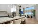 Modern kitchen with an island, breakfast bar, stainless steel appliances, pendant lights and open floor plan at 3540 Mistletoe Ln, Longboat Key, FL 34228