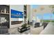 Modern living room with a large TV, fireplace, and views of the water and pool at 3540 Mistletoe Ln, Longboat Key, FL 34228