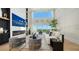 Bright living room features tall ceilings, floor to ceiling windows, fireplace and contemporary furniture at 3540 Mistletoe Ln, Longboat Key, FL 34228