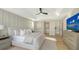 Neutral toned main bedroom features tray ceiling, fan, light wood floors, and ensuite bathroom at 3540 Mistletoe Ln, Longboat Key, FL 34228
