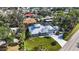 Stunning aerial view of a well-manicured home with a metal roof, lush lawn, and meticulously landscaped yard at 3595 Shamrock Dr, Venice, FL 34293