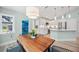 Bright and airy dining area with a rustic wooden table, modern chairs, and an open view to the kitchen at 3595 Shamrock Dr, Venice, FL 34293