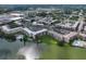 A stunning aerial view of the lakeside condo community with pools, docks, and lush landscaping at 3698 Lake Bayshore Dr # K-410, Bradenton, FL 34205