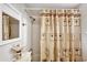 Bright bathroom with a shower and a decorative palm tree shower curtain at 3698 Lake Bayshore Dr # K-410, Bradenton, FL 34205