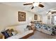 Comfortable bedroom with a convertible sofa, ceiling fans and framed artwork at 3698 Lake Bayshore Dr # K-410, Bradenton, FL 34205