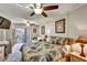 Cozy bedroom featuring a ceiling fan, balcony access, and tropical themed decor at 3698 Lake Bayshore Dr # K-410, Bradenton, FL 34205