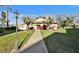 Charming community building with a landscaped walkway and exterior lighting at 3698 Lake Bayshore Dr # K-410, Bradenton, FL 34205