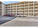 Condominium exterior showcasing multiple units, parking, and neutral color scheme at 3698 Lake Bayshore Dr # K-410, Bradenton, FL 34205