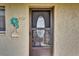 Condo's front door with leaded glass and a decorative welcome sign at 3698 Lake Bayshore Dr # K-410, Bradenton, FL 34205