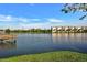 Beautiful lake view with a dock and a condominium building in the distance at 3698 Lake Bayshore Dr # K-410, Bradenton, FL 34205