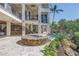 Lush backyard oasis featuring a stone-clad spa, pool, and cascading rock waterfall at 3935 N Shell Rd, Sarasota, FL 34242