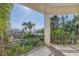 Expansive balcony offering serene ocean views, lush tropical foliage, and a relaxing outdoor space at 3935 N Shell Rd, Sarasota, FL 34242