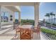 Balcony with outdoor seating and stunning views of the water and palm trees at 3935 N Shell Rd, Sarasota, FL 34242