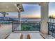 Spacious balcony featuring two chaise lounges overlooking tranquil ocean views at sunset at 3935 N Shell Rd, Sarasota, FL 34242