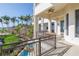 Gorgeous balcony overlooking lush landscaping and a pool, showcasing the property's outdoor living space at 3935 N Shell Rd, Sarasota, FL 34242
