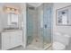 Bathroom featuring a glass enclosed shower, marble countertops, and white cabinets at 3935 N Shell Rd, Sarasota, FL 34242