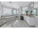 Bathroom showcasing a walk-in shower, soaking tub, and dual sinks with vanities at 3935 N Shell Rd, Sarasota, FL 34242