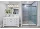 Elegant bathroom with a modern vanity, large mirror, and glass-enclosed shower with stylish gray tiling at 3935 N Shell Rd, Sarasota, FL 34242