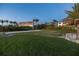 Beach volleyball court in front of luxury homes surrounded by lush landscaping and tall palm trees at 3935 N Shell Rd, Sarasota, FL 34242