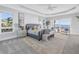 Spacious bedroom with light gray walls, balcony access and ocean views at 3935 N Shell Rd, Sarasota, FL 34242