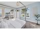 Bright bedroom with waterfront views, a canopy bed, and stylish furnishings for a serene retreat at 3935 N Shell Rd, Sarasota, FL 34242