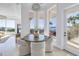 Bright breakfast nook with water views, modern lighting fixture, and outdoor access at 3935 N Shell Rd, Sarasota, FL 34242