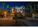 Elegant home featuring a gated entrance, a circular driveway, manicured landscaping, and mature palm trees at 3935 N Shell Rd, Sarasota, FL 34242