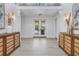 Grand foyer featuring wood floors, decorative lighting, and custom built-in cabinets at 3935 N Shell Rd, Sarasota, FL 34242