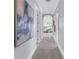 Hallway with views into an adjacent bedroom featuring neutral colored walls and carpeted floor at 3935 N Shell Rd, Sarasota, FL 34242