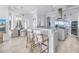 Modern kitchen featuring stainless steel appliances, white cabinetry, and a breakfast bar at 3935 N Shell Rd, Sarasota, FL 34242