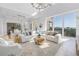Spacious living area with modern furniture, water views, and open floor plan at 3935 N Shell Rd, Sarasota, FL 34242