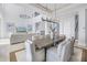 Open floor plan with a large dining table and living room area, featuring bright, neutral tones at 3935 N Shell Rd, Sarasota, FL 34242