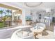 Open floor plan living area leading to kitchen and outdoor balcony with water views at 3935 N Shell Rd, Sarasota, FL 34242