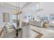 Bright, open living space with travertine floors, decorative lighting, and views of the bay at 3935 N Shell Rd, Sarasota, FL 34242