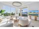 Bright living room with scenic views of the water. Features elegant seating, an elegant chandelier and modern design elements at 3935 N Shell Rd, Sarasota, FL 34242