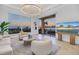 Bright living room with stunning water views, modern decor, and balcony access at 3935 N Shell Rd, Sarasota, FL 34242
