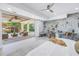 A luxurious bedroom boasting a private patio, stone accent wall, and tranquil views of the pool and landscape at 3935 N Shell Rd, Sarasota, FL 34242