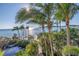 Scenic ocean view through lush palm trees with white sand below reflecting sunlight on a clear day at 3935 N Shell Rd, Sarasota, FL 34242