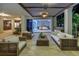 Luxurious outdoor living space with comfortable seating, overlooking a bedroom and bar area at 3935 N Shell Rd, Sarasota, FL 34242