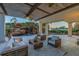 A covered patio features outdoor seating and views of the lush landscaping, waterfall, and lake at 3935 N Shell Rd, Sarasota, FL 34242