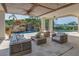 A spacious covered patio with bamboo ceiling and water views features outdoor seating and beautiful landscaping with a waterfall at 3935 N Shell Rd, Sarasota, FL 34242