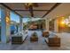 A spacious covered patio with bamboo ceiling features outdoor seating, landscaping, and a waterfall flowing into the pool at 3935 N Shell Rd, Sarasota, FL 34242