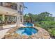 Stunning pool and spa area with lush landscaping and a soothing waterfall feature at 3935 N Shell Rd, Sarasota, FL 34242