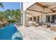 Inviting outdoor space with pool, patio, covered seating area, and lush tropical landscaping at 3935 N Shell Rd, Sarasota, FL 34242