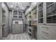 Walk-in closet with custom closet system, neutral carpet, and a decorative chandelier at 3935 N Shell Rd, Sarasota, FL 34242
